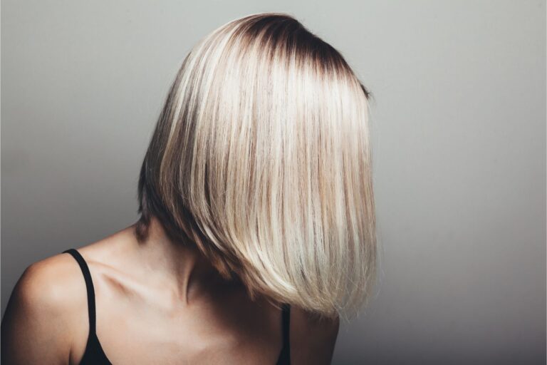 Woman with a short blonde pixie bob cut.